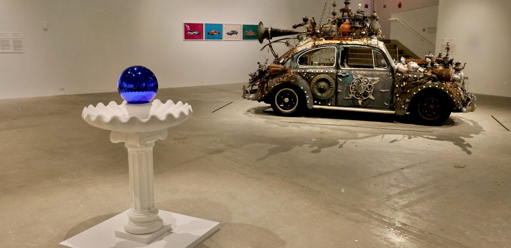 ''Gazing Ball (Birdbath)'' by Jeff Koons is juxtaposed with Clarke Bedford's ''Art Car (Volkswagen)'' at the Institute of Contemporary Art exhibit exploring the history and impact of yard art. (Emma Lee/WHYY)