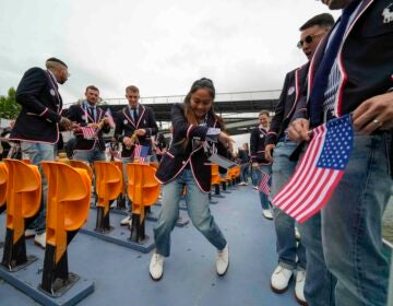 Logan Edra, of the United States breakdancing team, dances as she travels along with teammates on the Seine River in Paris, France, during the opening ceremony of the 2024 Summer Olympics, Friday, July 26, 2024. (AP Photo/Ashley Landis, Pool)
