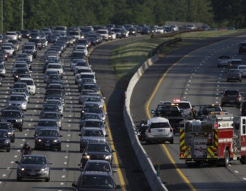 An emergency vehicle, bottom right, stands near the scene of a two-vehicle accident on the southbound side of the Garden State Parkway in Clark, N.J. (AP Photo/Julio Cortez)