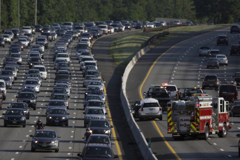 An emergency vehicle, bottom right, stands near the scene of a two-vehicle accident on the southbound side of the Garden State Parkway in Clark, N.J. (AP Photo/Julio Cortez)