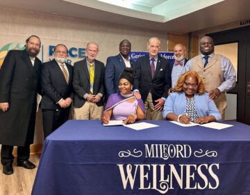 The official signing of the $5 million, five-year Geriatric Workforce Enhancement Program that will take place at the Milford Wellness Village, the projects base location. (Johnny Perez-Gonzalez/WHYY)