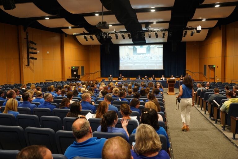 Great Valley Education Association President Nikki Salvatico walks down the aisle in the auditorium after ushering the other teachers in. (Kenny Cooper/WHYY News)