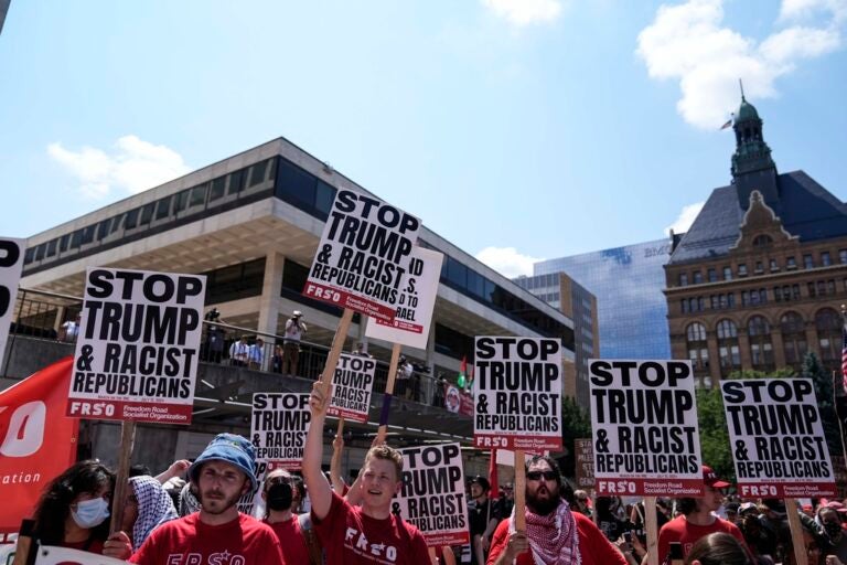 Protestors speak at Red Arrow Park near the Fiserv Forum during the first day of the 2024 Republican National Convention, Monday, July 15, 2024, in Milwaukee. (AP Photo/Jae C. Hong)