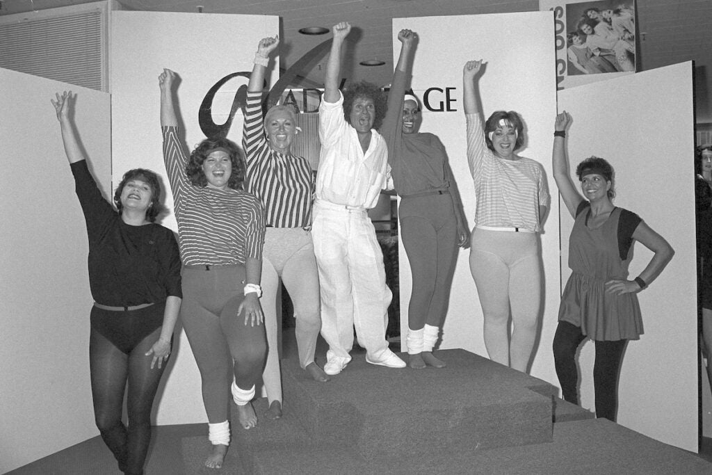 Richard Simmons, center, is surrounded by models