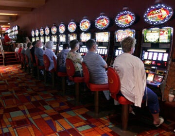 People playing slot machines in the casino