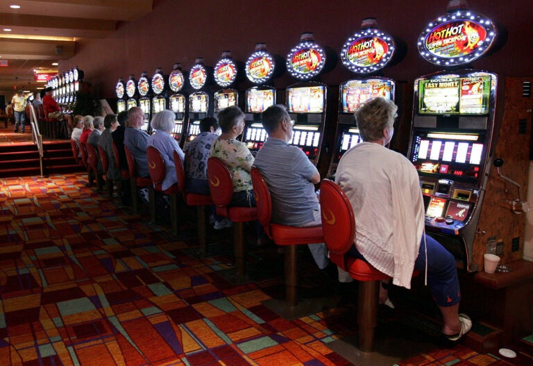 People playing slot machines in the casino