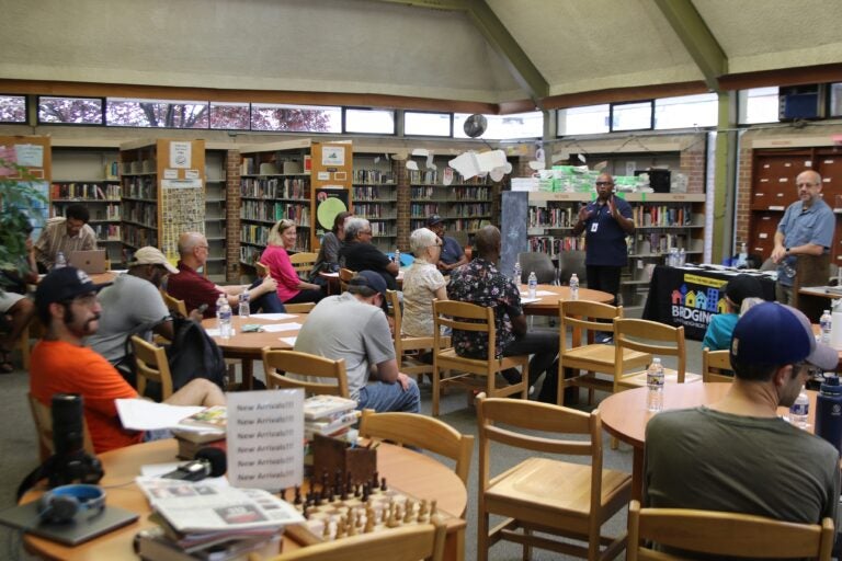 12 people sit in chairs at the library