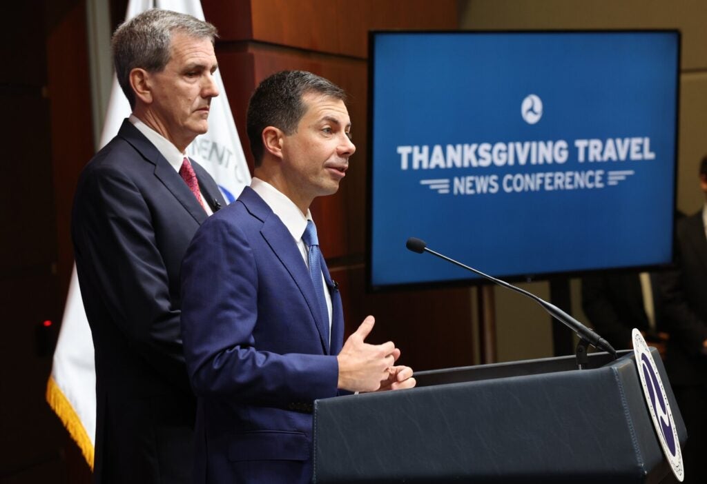 Pete Buttigieg speaking at a podium