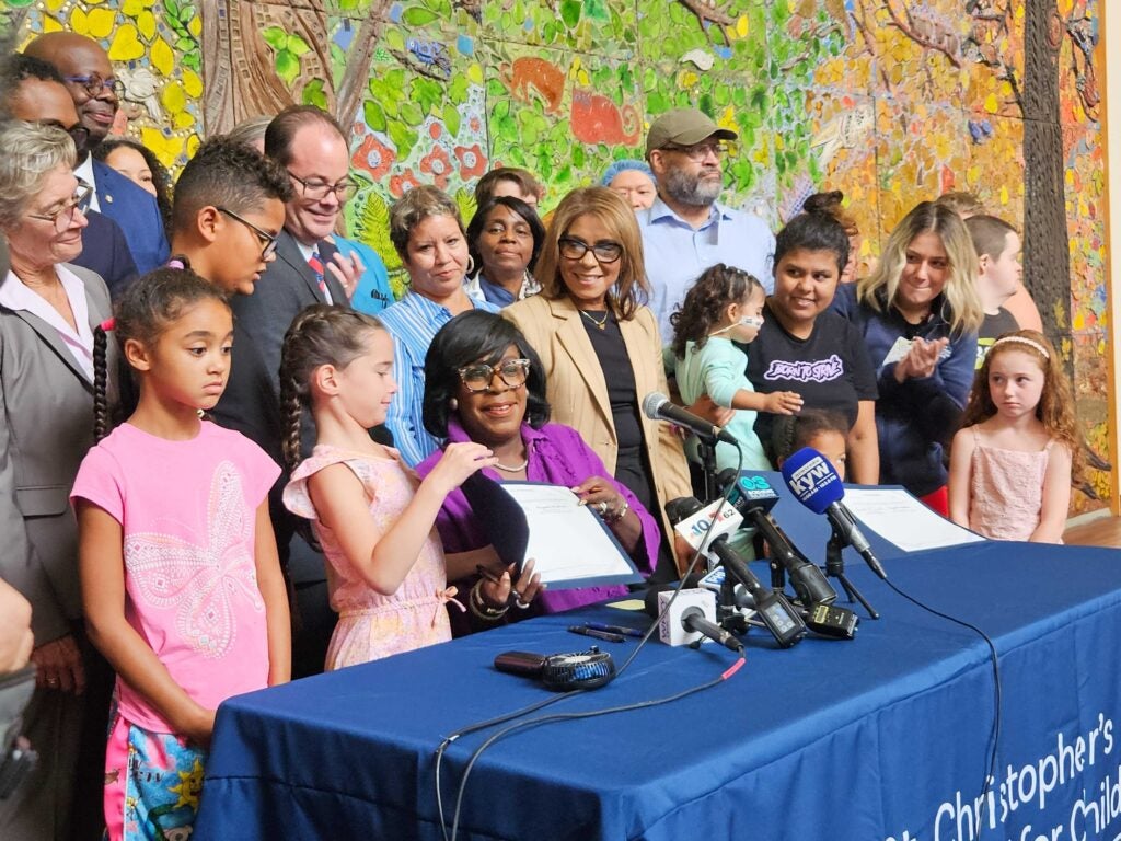 Mayor Cherelle Parker signs bills alongside children and officials