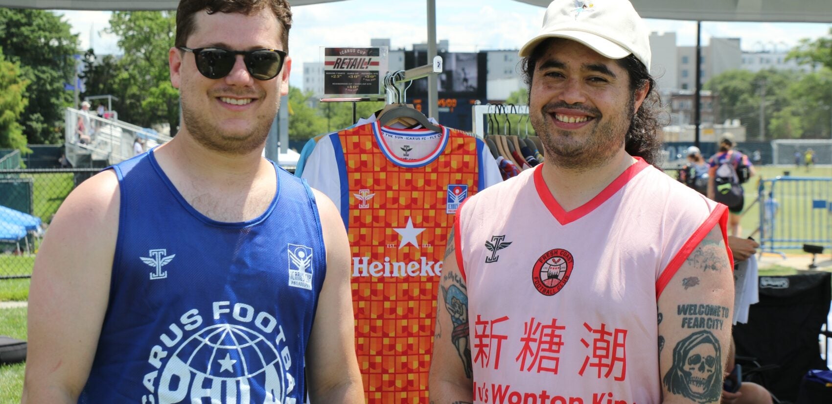 Icarus Football founder Robby Smukler (left) and operation manager Diego Gallardo (right) held down the fort at the merch tent on Saturday. (Cory Sharber/WHYY)