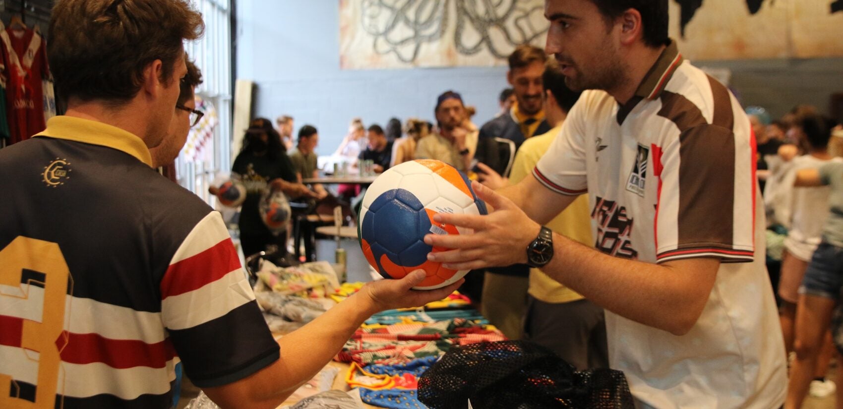 Players picked up their kits and soaked up the vibes during a pre-tournament gathering at Craft Hall on Friday. (Cory Sharber/WHYY)