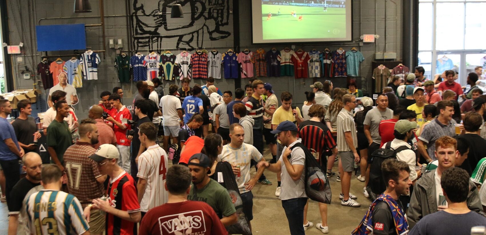 Players picked up their kits and soaked up the vibes during a pre-tournament gathering at Craft Hall on Friday. (Cory Sharber/WHYY)