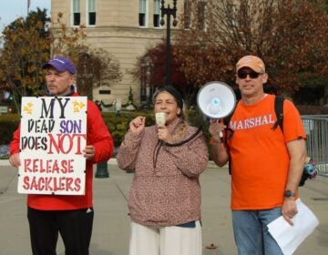 Susan Ousterman and two others at a protest
