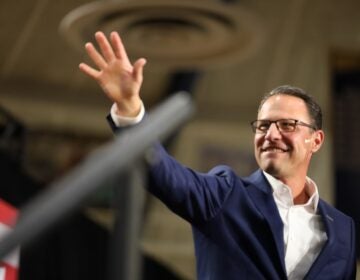 Gov. Josh Shapiro waves to the crowd at a campaign event in Montgomery County for Kamala Harris with Gov. Gretchen Whitmer of Michigan. (Carmen Russell-Sluchansky)