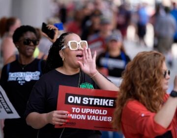 A demonstrator chants while picketing in support of the National Education Association Staff Organization outside the Pennsylvania Convention Center, Friday, July 5, 2024, in Philadelphia.