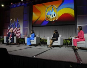 Republican presidential nominee and President Donald Trump speaks at a panel moderated by, from left, ABC's Rachel Scott, Semafor's Kadia Goba and Fox News' Harris Faulkner at the National Association of Black Journalists convention Wednesday in Chicago. (NPR/Charles Rex Arbogast/AP)