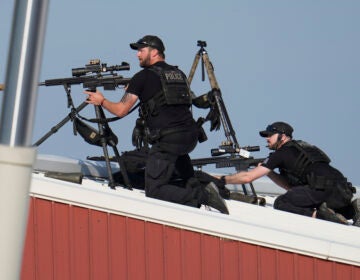 Police snipers return fire after shots were fired while Republican presidential candidate former President Donald Trump was speaking at a campaign event in Butler, Pa., on Saturday, July 13, 2024. (AP Photo/Gene J. Puskar)