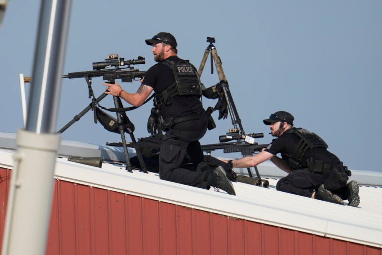 Police snipers return fire after shots were fired while Republican presidential candidate former President Donald Trump was speaking at a campaign event in Butler, Pa., on Saturday, July 13, 2024. (AP Photo/Gene J. Puskar)