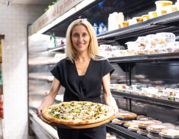 Rosita Lamberti, director of restaurants for the Aldo Lamberti family of restaurants, holds a pizza inside Lamberti’s at 7th and Chestnut in Center City, Philadelphia