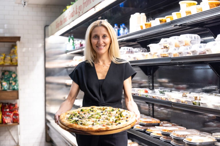 Rosita Lamberti, director of restaurants for the Aldo Lamberti family of restaurants, holds a pizza inside Lamberti’s at 7th and Chestnut in Center City, Philadelphia