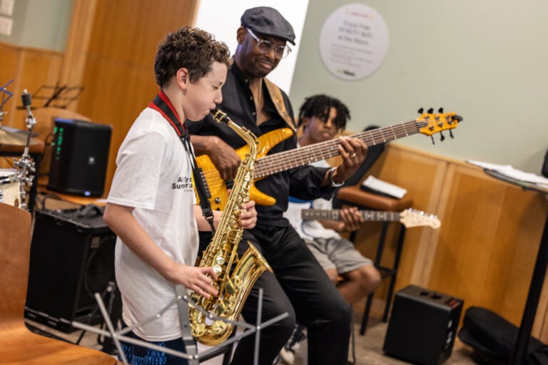 Joshua Ahati plays saxophone, Elaine Becton plays guitar and Gerald Veasley plays bass