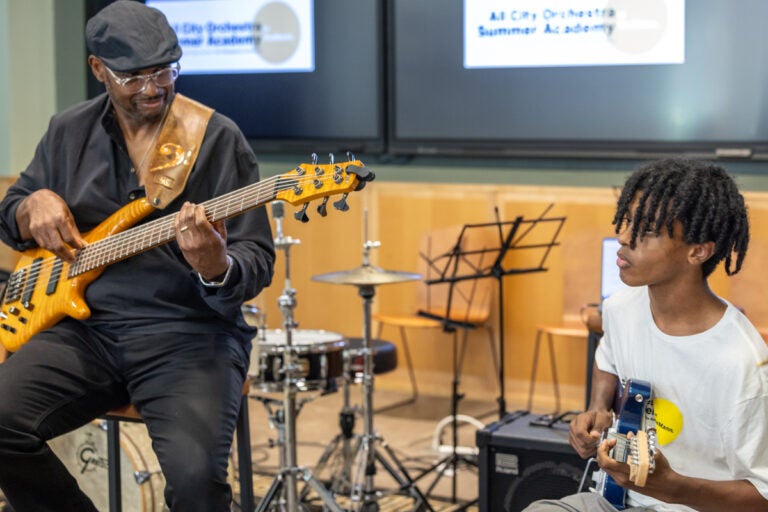 Elaine Becton plays guitar and Gerald Veasley plays bass