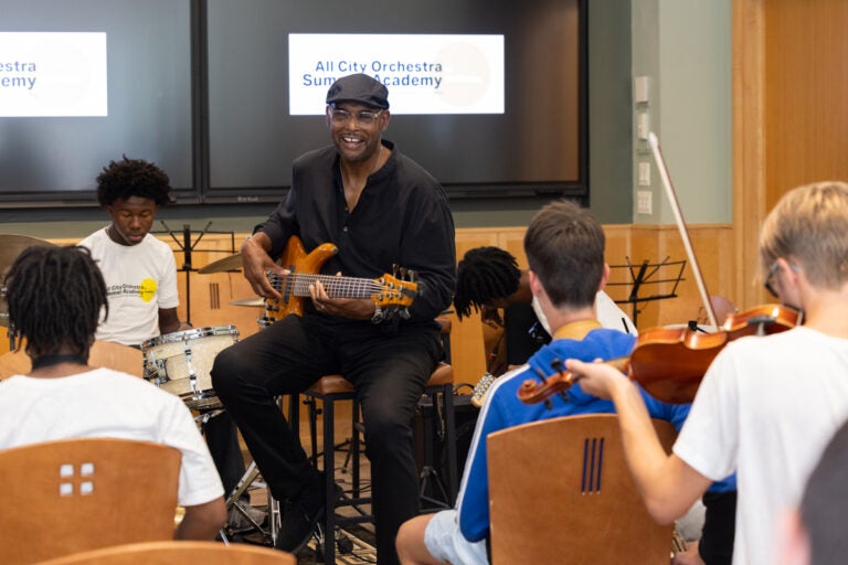 Gerald Veasley plays bass in a group jam session with students