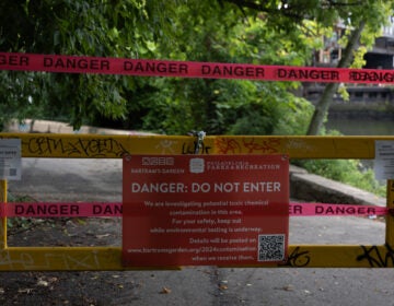 A sign on a gate stating that part of the Bartram's Garden hiking trail in Philadelphia is closed