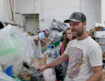 Matt Siegfrield showing the types of plastic they recycle