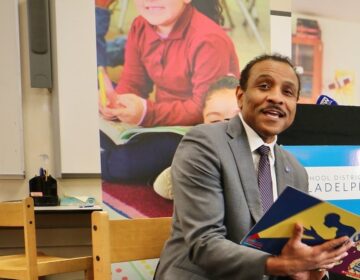 Tony Watlington reading to a group of students