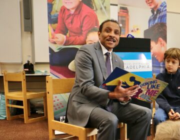 Tony Watlington reading to a group of students