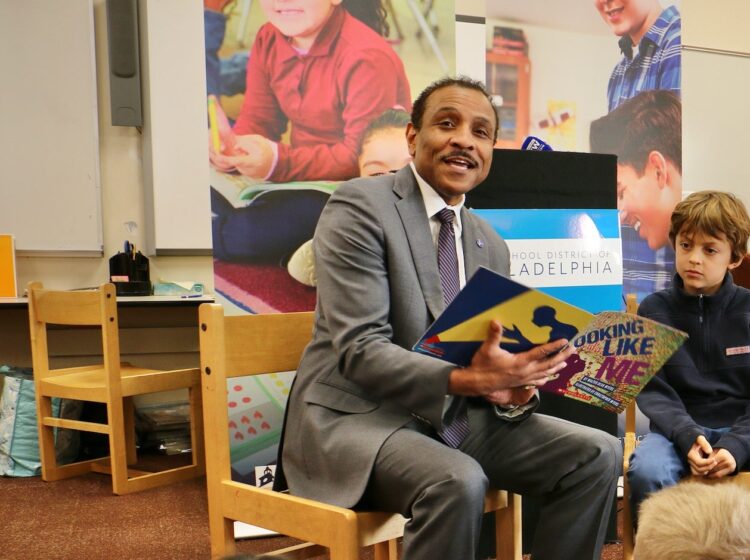 Tony Watlington reading to a group of students