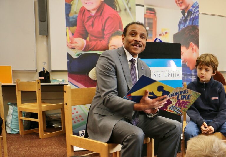 Tony Watlington reading to a group of students