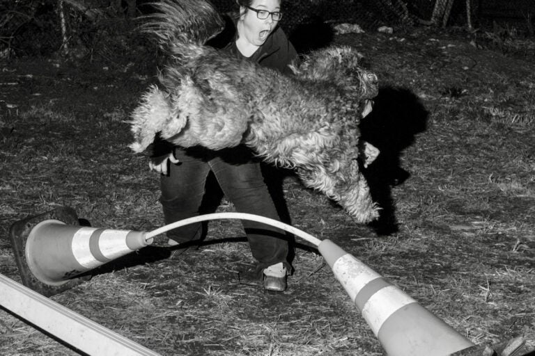 Anne Erickson runs while holding her dog