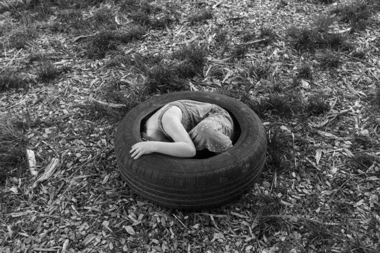 a kid sits in a tire