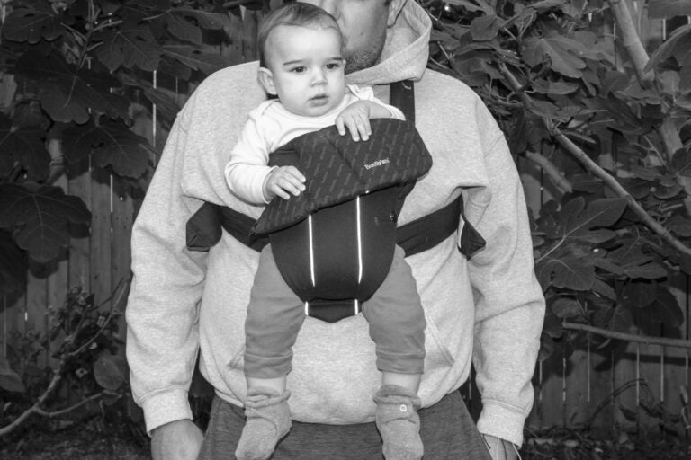 John Wisotsky with his baby son in a baby carrier