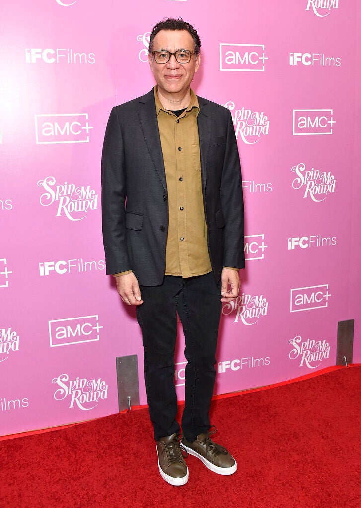 actor and comedian Fred Armisen stands in front of a pink background