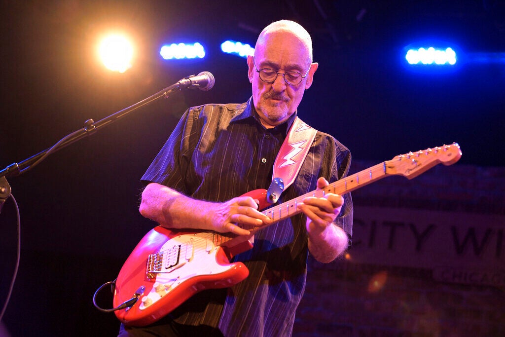 Man plays guitar on stage