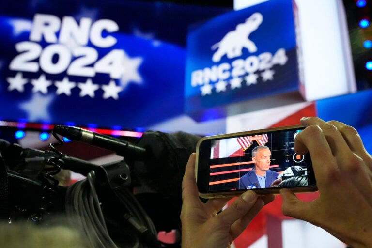 Corey Lewandowski is seen on the screen of a cellphone during a walkthrough at the 2024 Republican National Convention, Sunday, July 14, 2024, in Milwaukee. (AP Photo/Nam Y. Huh)