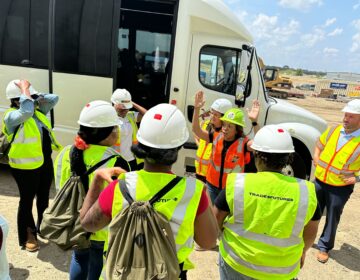 workers outside a bus