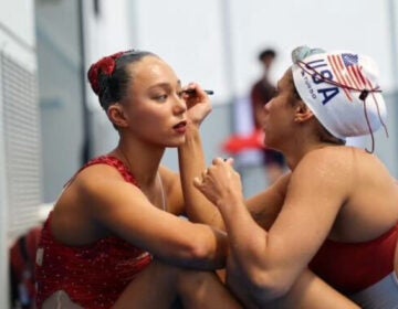 On the left, Megumi Field receives makeup from her teammate in Japan as she prepares for the 2023 World Championships, where they secured the first U.S. medal on the world stage in 16 years. (Courtesy of Alyssa Jacobs)