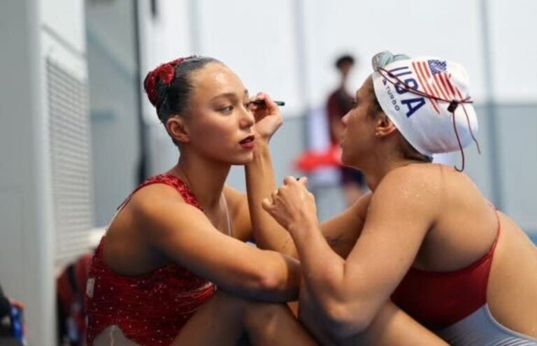 On the left, Megumi Field receives makeup from her teammate in Japan as she prepares for the 2023 World Championships, where they secured the first U.S. medal on the world stage in 16 years. (Courtesy of Alyssa Jacobs)