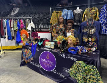 Two women with PSR Galleria Rosetta pose at their stall at the Wells Fargo Center