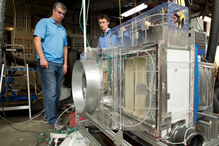 NREL engineers Eric Kozubal, left, and Jason Woods conduct initial research on the Blue Frontier prototype, the first sustainable HVAC system capable of reducing CO2 emissions by 85%. (Photo by Dennis Schroeder/NREL 20175)