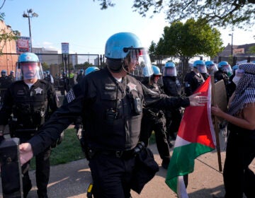 Police direct protesters at the United Center after a march at the Democratic National Convention Monday, Aug. 19, 2024, in Chicago. (AP Photo/Alex Brandon)