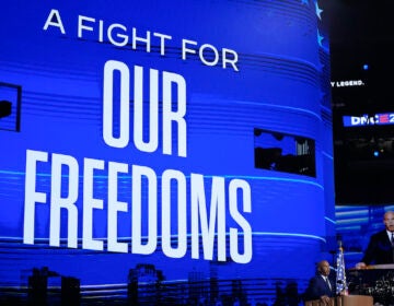 Cory Booker speaks in front of a screen reading A FIGHT FOR OUR FREEDOMS