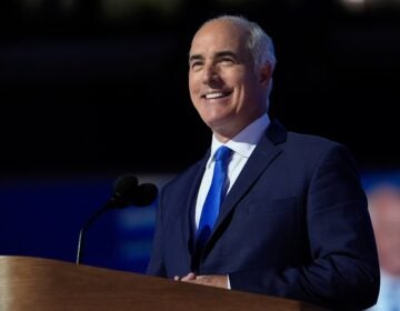 Bob Casey smiles behind a podium