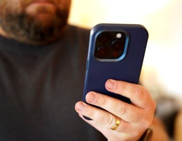 a person holds a cell phone