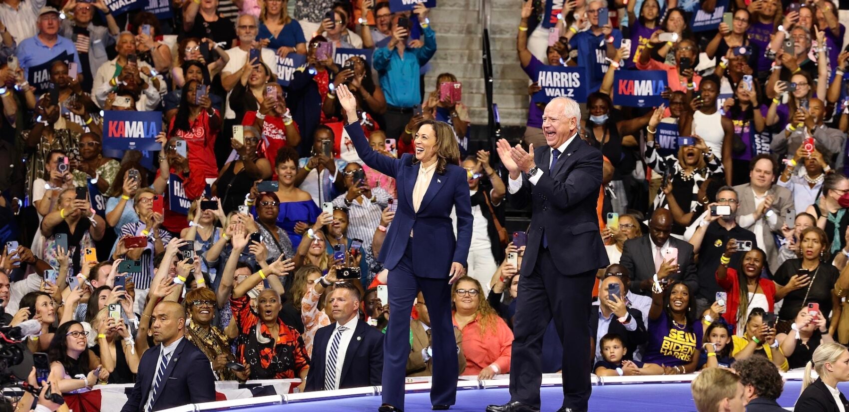 Kamala Harris Tim Walz greet the crowd at the rally