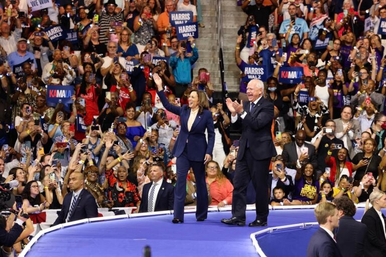 Kamala Harris Tim Walz greet the crowd at the rally